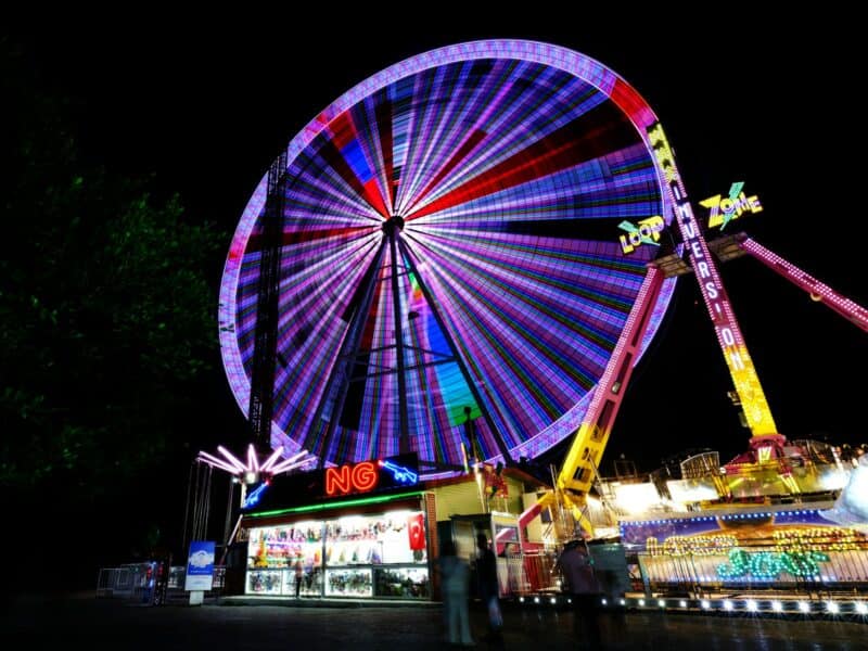 a ferris wheel lit up at night at a carnival